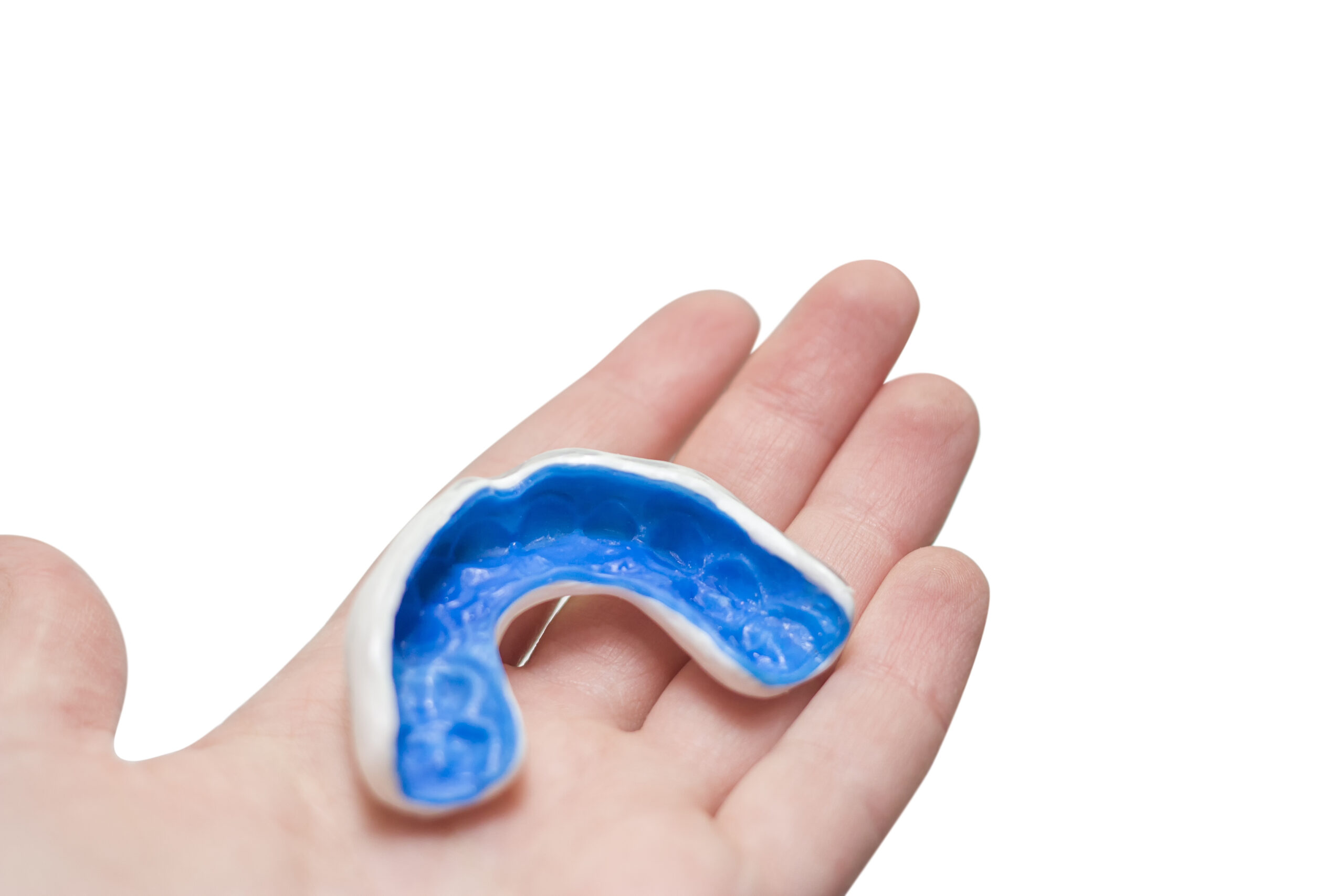 Hand with white sport mouthguard