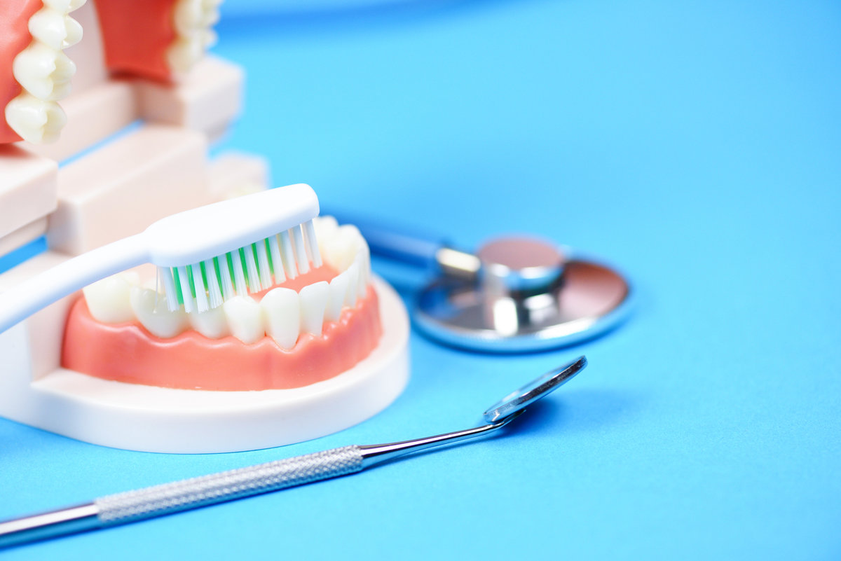 Dental care concept / dentist tools with dentures dentistry instruments and dental hygiene and equipment checkup with teeth model and mouth mirror oral health